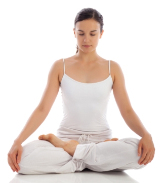 young woman in white yoga clothes mediating with legs crossed