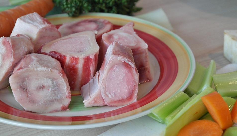 plate of porkchops surrounded by carrots and celery