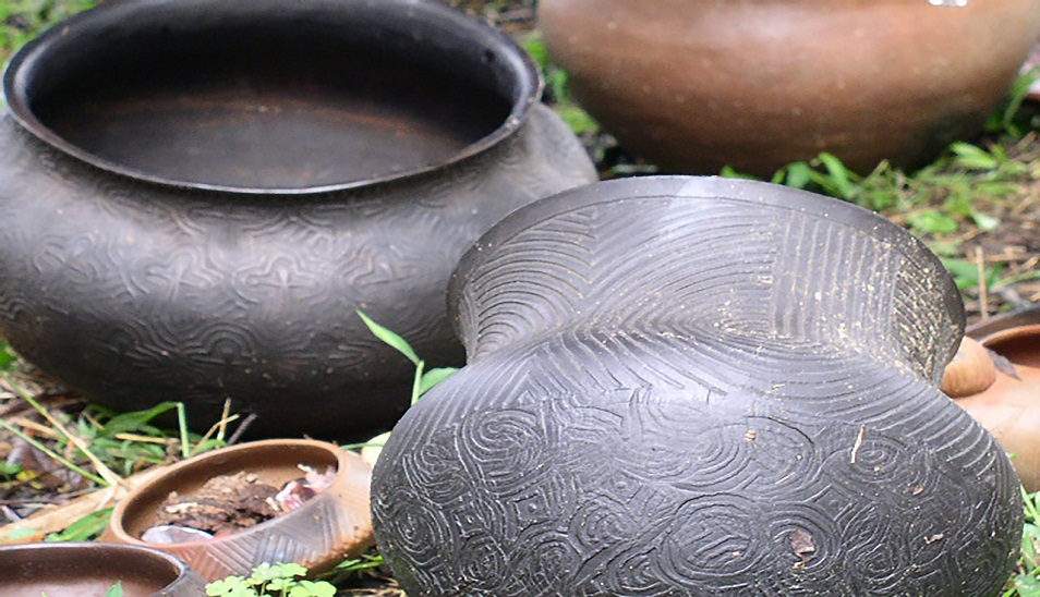 textured clay pots sitting on ground