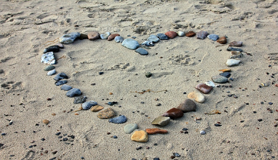 rocks on beach outlining a heart symbol