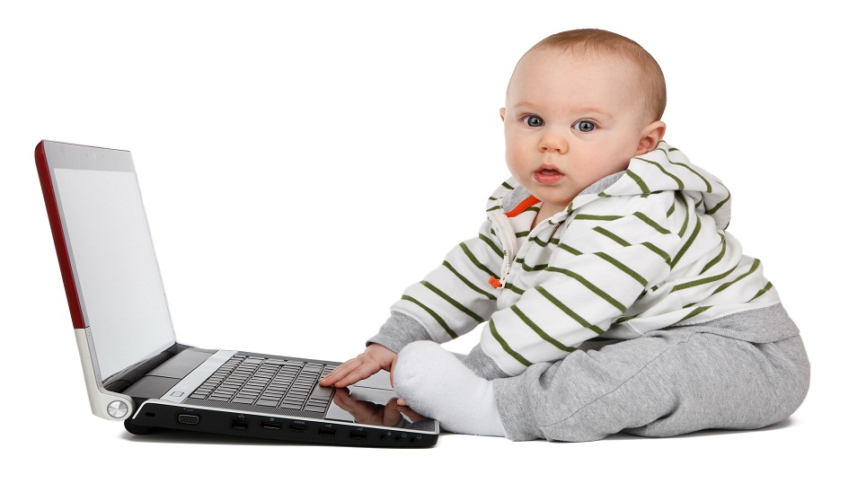 toddler typing on laptop