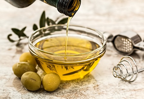 Olive Oil pouring into bowl