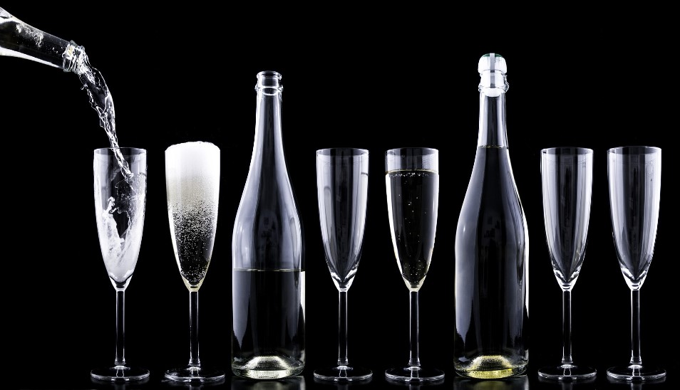 bottles and glasses filled with champagne