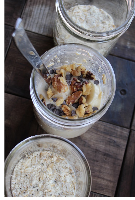 3 glass jars on wood table filled with pieces of bananas, walnuts and oats