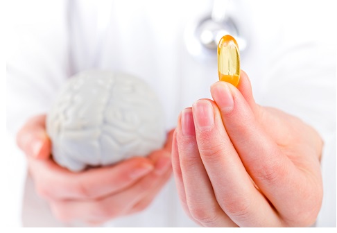 Closeup photo of doctor holding omega 3 capsule in hand