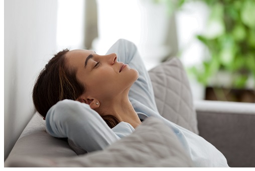 happy woman sleeping restfully on couch 