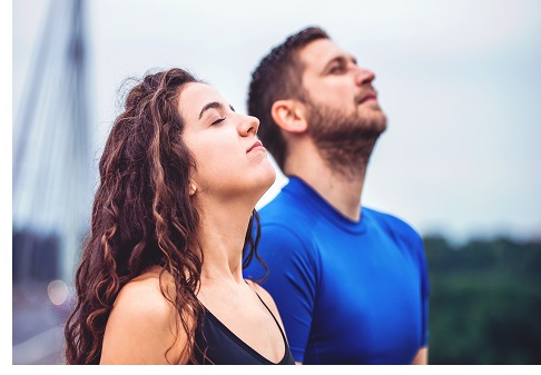 Breath a fresh air. Young couple enjoys together in the morning training outdoor. Sport, fitness, recreation concept