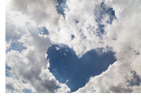 Blue sky with heart shaped form by cloud