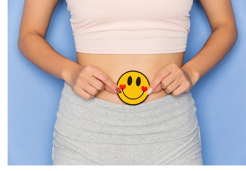 happy-gut-health.-woman-with-smiley-face-next-to-stomach.