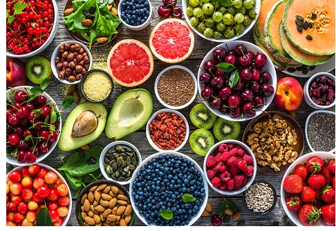 Selection of healthy food. Superfoods, various fruits and assorted berries, nuts and seeds.