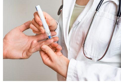 Measuring blood sugar on finger - diabetes and glicemia concept